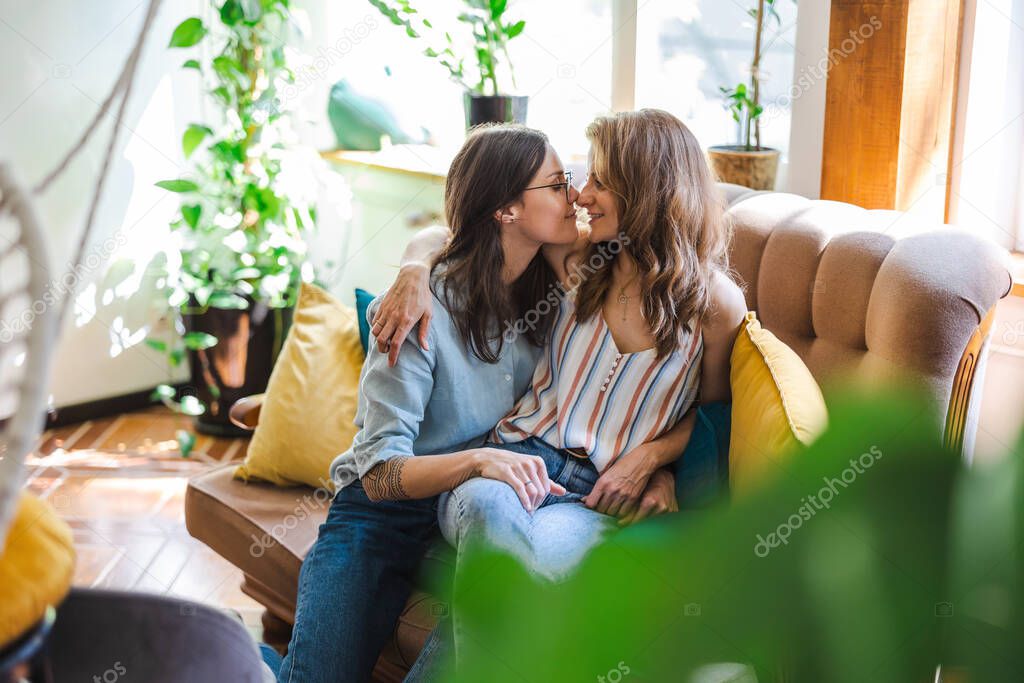 Happy affectionate lesbian couple at home