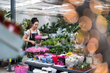 Bahçe merkezinde çalışan bir kadın.