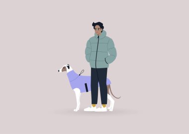 Genç bir erkek tazı sahibi evcil hayvanlarıyla yürüyor, kış mevsimi, köpek kıyafetleri.