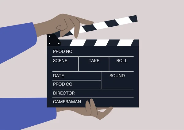 映像と音を同期させるために映画制作や映像制作に使われる装置であるクラッパーボードを手に取り — ストックベクタ
