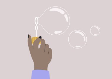 A hand holding a soap bubble blower