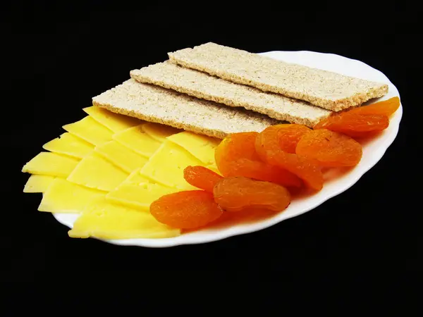 Dried fruits with cheese and diet wholegrain bread — Stock Photo, Image