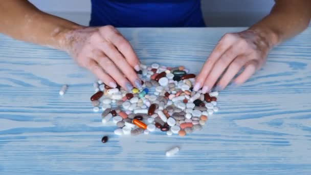 Close Hands Girl Vitiligo Choose Pills Offer Red Blue Skin — Stock Video