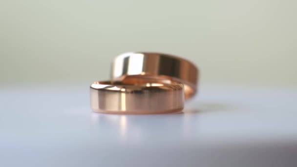 Two Gold Wedding Rings Rotate White Background Macro Photography — Stock Video