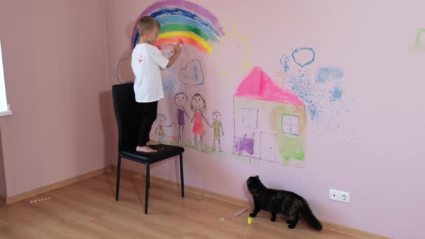 Little Boy Standing Chair Draws Rainbow Wall Wallpaper Black Cat — Stock Video