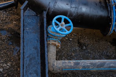 Blue valve close-up on the drain tube in the well.