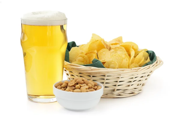 Beer pint with peanuts bowl and basket of crisps — Stock Photo, Image