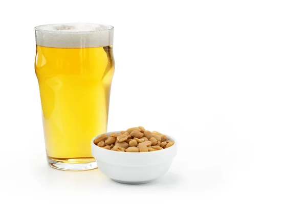 Pint of lager and peanuts Stock Photo