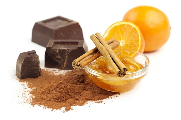 Marmalade, cinnamon and chocolate on white background — Stock Photo, Image