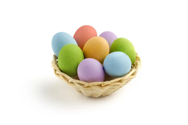 Basket of colored easter eggs on white background — Stock Photo, Image