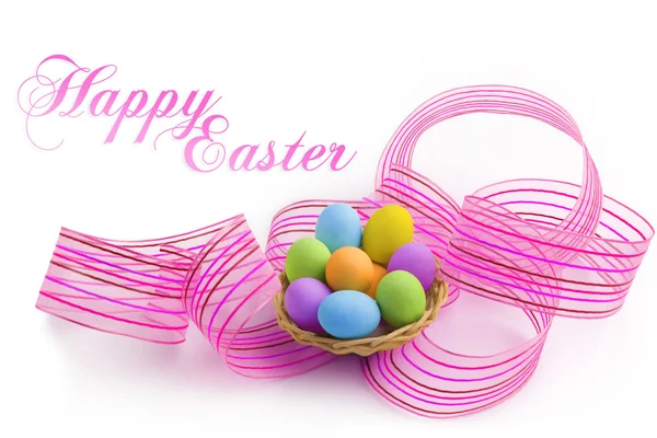 Nest of colored easter eggs with pink ribbon — Stock Photo, Image