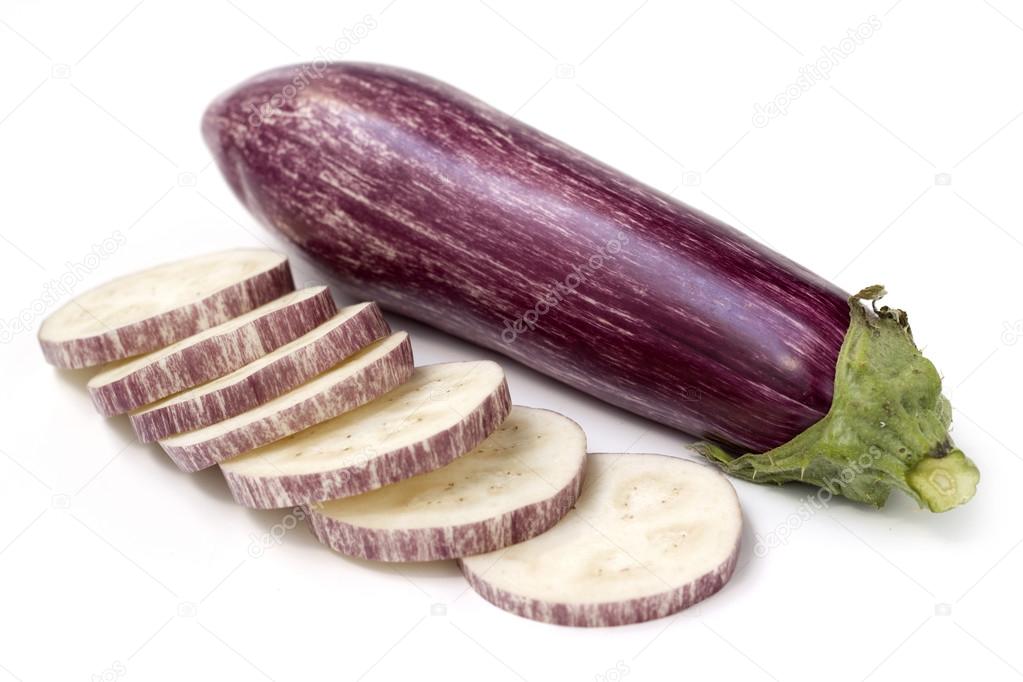 slices of eggplant and whole fruit on white background