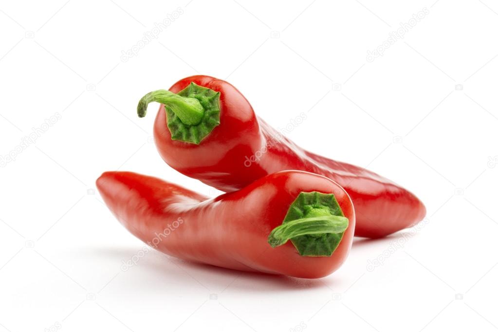 close up of two chilies on white background