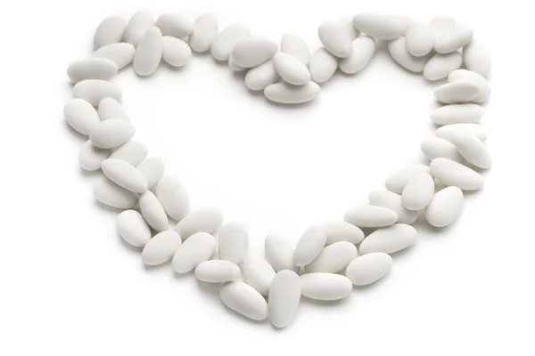 Heart of sugared almonds on white background — Stock Photo, Image