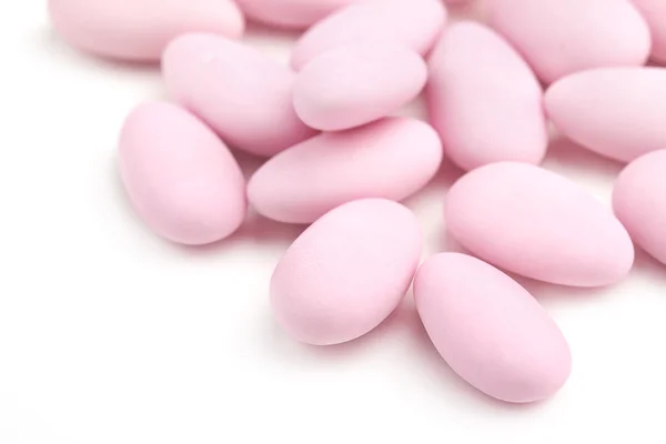 Pastel rose sugared almonds on white background — Stock Photo, Image