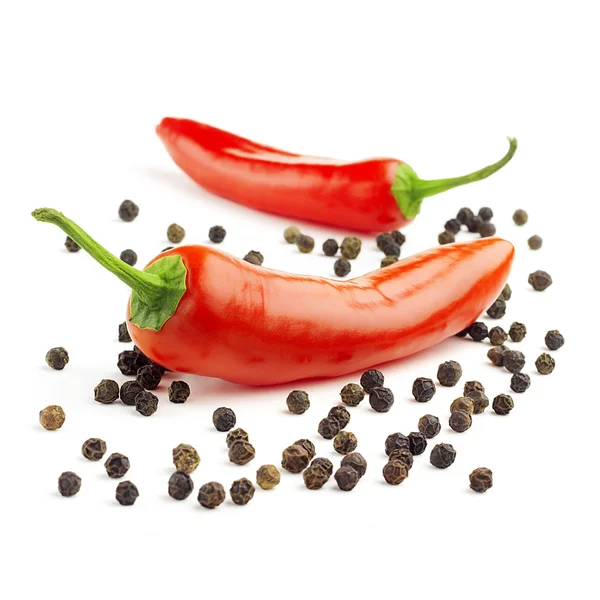 Chili peppers and black peppercorns on white background — Stock Photo, Image