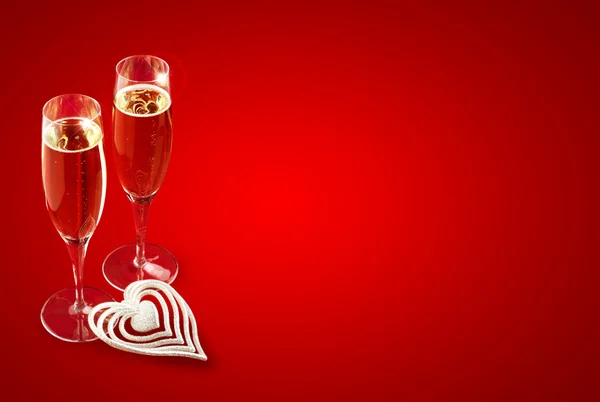 A pair of champagne glasses on red background — Stock Photo, Image