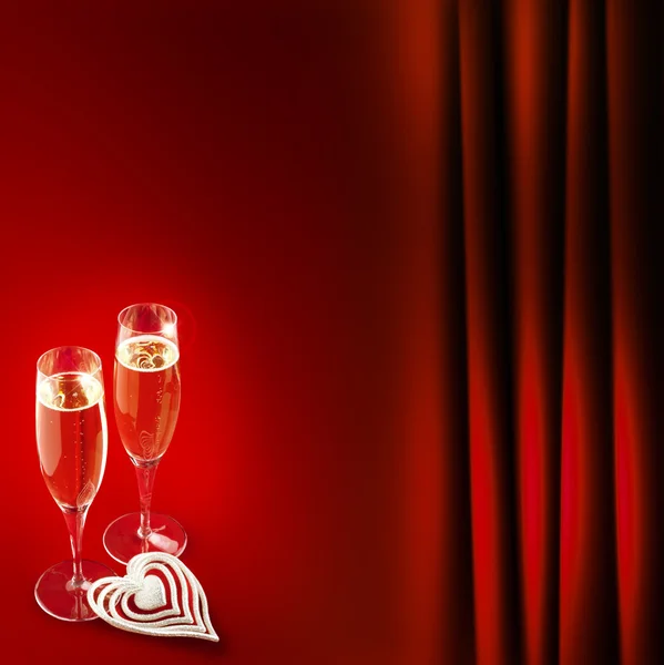 Two champagne glasses with heart on red background — Stock Photo, Image