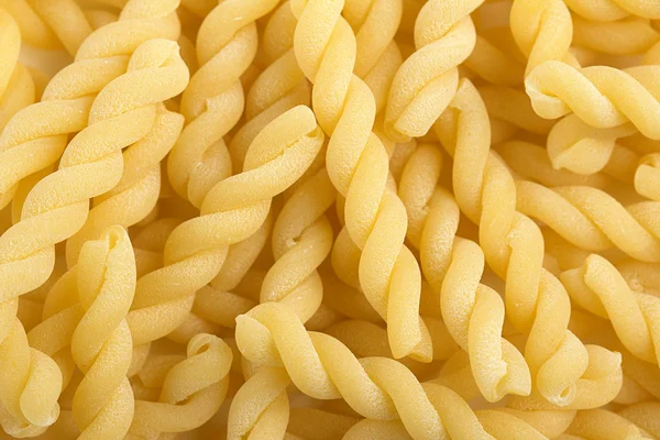 Bakgrund av italiensk traditionell pasta spiral-formade — Stockfoto