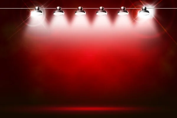 Sahne ışıkları ve pırıltılar tarafından aydınlatılan kırmızı bir arka plan — Stok fotoğraf