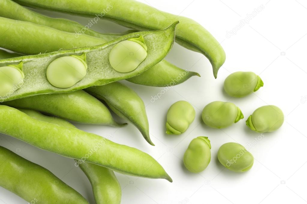 Broad bean pods and seeds on white background