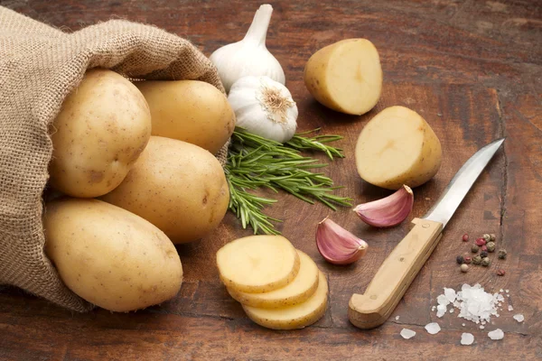 Jutesack mit rohen Kartoffeln, Gewürzen und geschnittenen Kartoffeln — Stockfoto