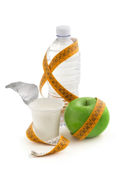 Yogurt, apple and bottle of water wrapped by a measuring tape — Stock Photo, Image