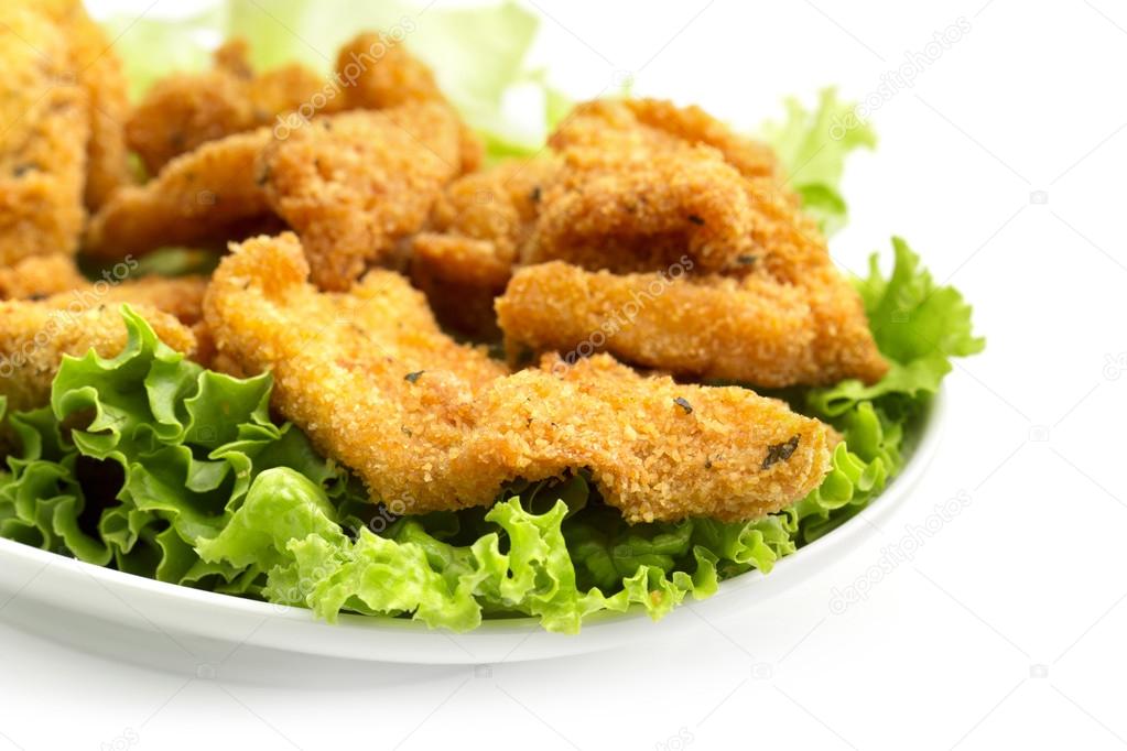 Detail of a dish of fried chicken on lettuce