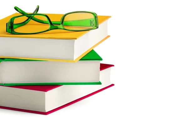 Stack of books with a peair of eyeglasses on top — Stock Photo, Image