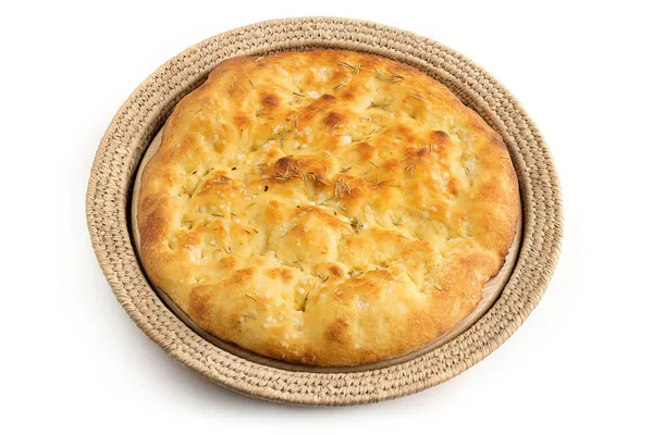 Whole focaccia in a straw tray over white — Stock Photo, Image