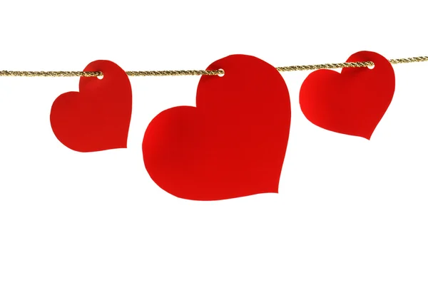 Tre carte a forma di cuore appese a uno spago d'oro — Foto Stock