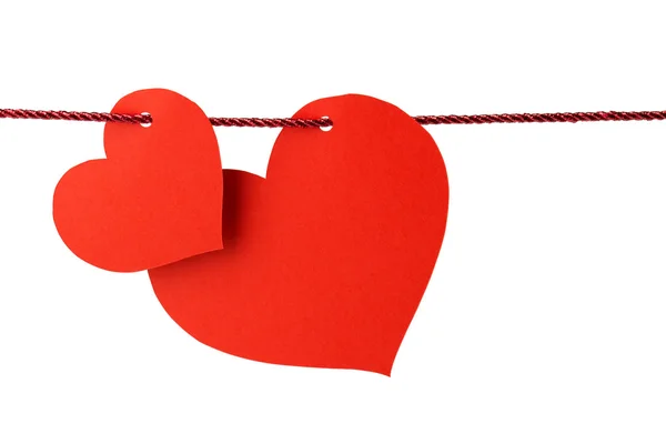 Two cards in the shape of heart hanging from a red cord — Stock Photo, Image