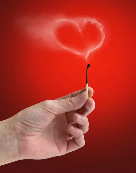 Extinguished matchstick with a wisp of smoke heart-shaped — Stock Photo, Image