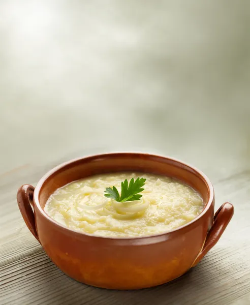 Steaming bowl of potato soup on wooden table — Stock Image Steaming bowl of potato soup on wooden table Stock Image