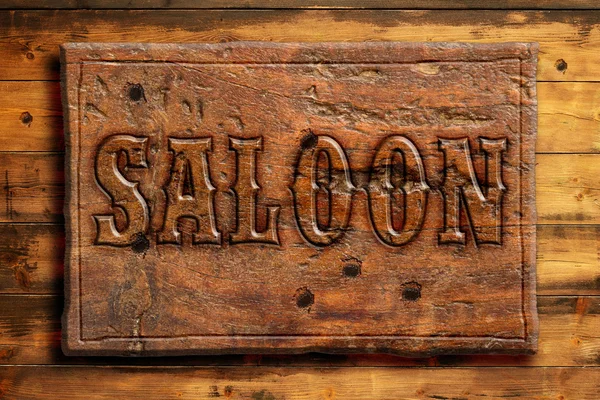 Signboard of saloon on a wooden wall — Stock Photo, Image