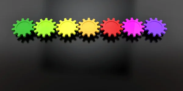 Colorful gears in row on black background — Stock Photo, Image