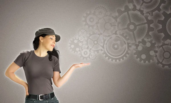 Woman with open hand showing a cogwheels complex — Stock Photo, Image