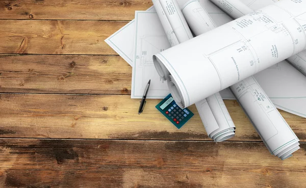 Blueprints, pen and calculator on wooden table — Stock Photo, Image