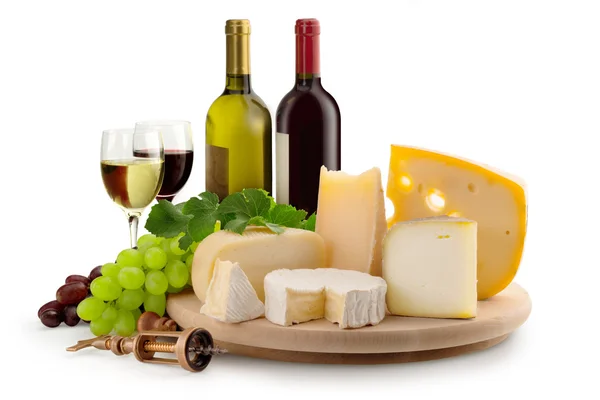 Cheeseboard, grapes, wineglasses and wine bottles — Stock Photo, Image