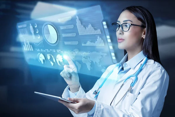 Female Doctor Holding Tablet Computer Touching Medical Graphs Virtual Screen — ストック写真