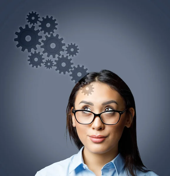 Portrait Young Woman Wearing Glasses Looking Cogwheels Isolated Grey Background — Stock Photo, Image