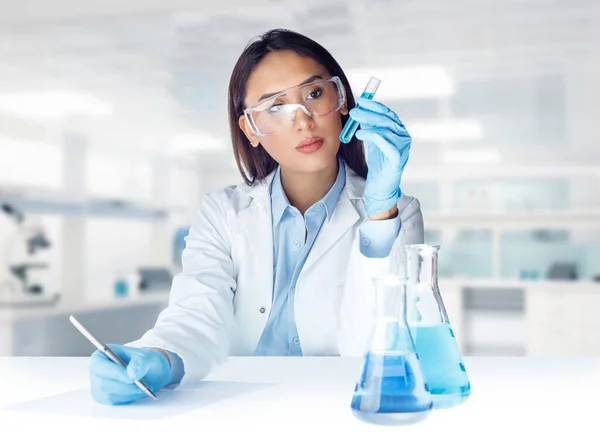 Female Chemist Wearing Lab Coat Glasses Gloves Holding Test Tube — Stok fotoğraf