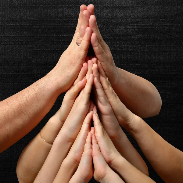 Family hands on a black background Stock Picture