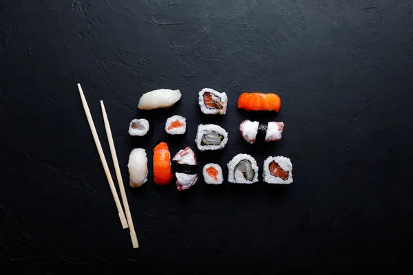 japanese sushi food. Maki ands rolls with tuna, salmon, shrimp, crab and avocado. Top view of assorted sushi.