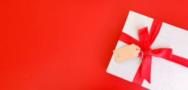 Red banner with gift box tied red ribbons..