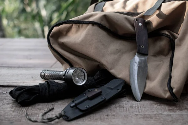 A knife with equipment for survival in the forest