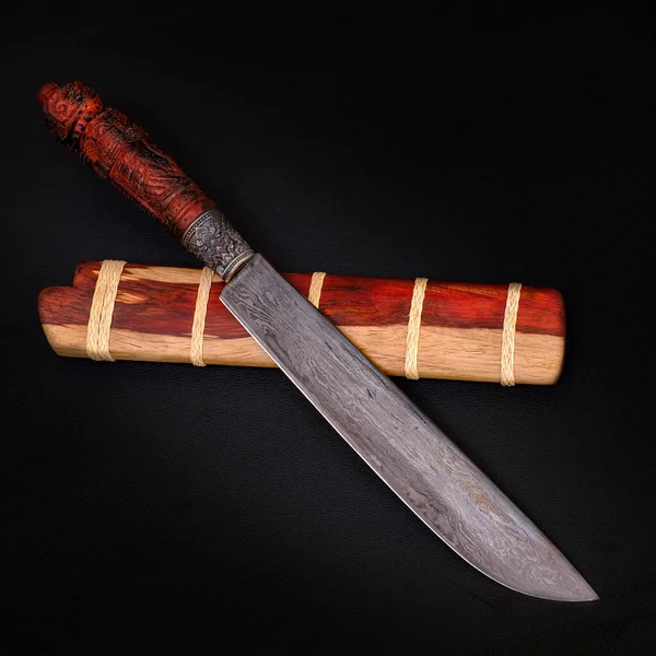 Damascus camping knife  custom in the natural Tiger patterned wood casing on black background handmade of Thailand