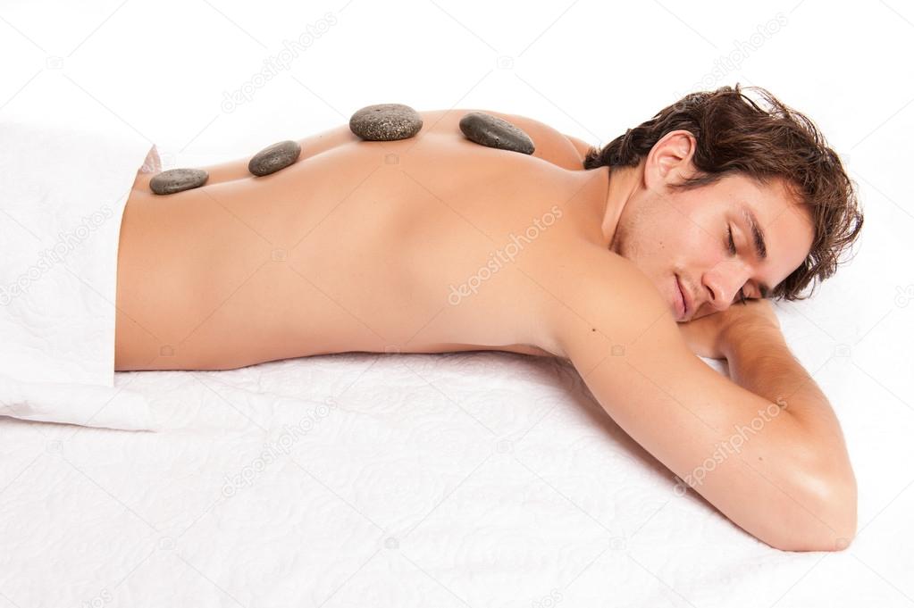 man receiving a hot stone massage.