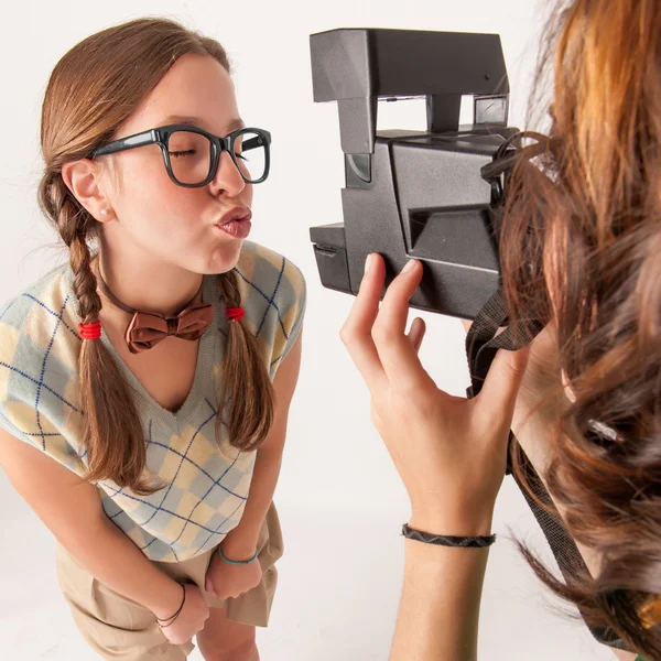 Young nerdy girls using instant camera. — Stock Photo, Image