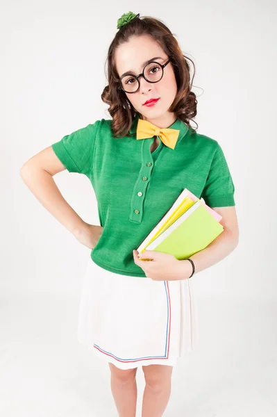Nerdy girl holding books looking at camera. — Stock Photo, Image